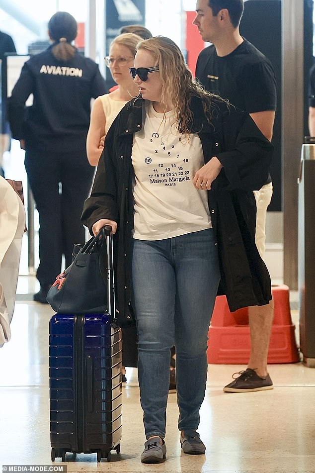 The Australian actress hid her eyes behind large, dark designer sunglasses and opted for a casual look as she donned a $646 Maison Margiela T-shirt