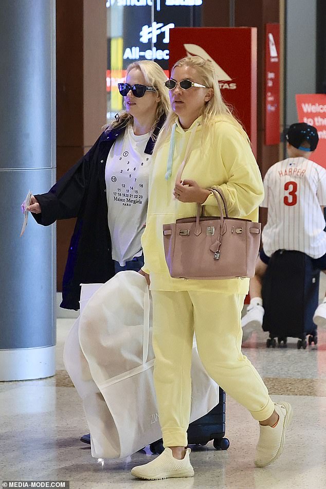 Ramona also hid her eyes behind sunglasses and carried a Zimmerman garment bag in one hand and a Hermes Birkin in the other.