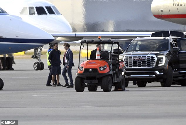 Zuckerberg walked from his car to his Gulfstream G650 jet at Palm Beach International Airport, wearing a navy blue suit and an appropriate red tie.