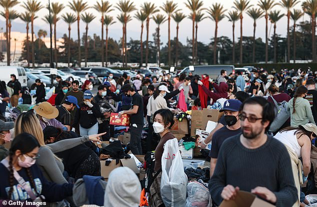 People collect and sort donated clothing and other items at a pop-up donation center for wildfire victims at the Santa Anita Race Track