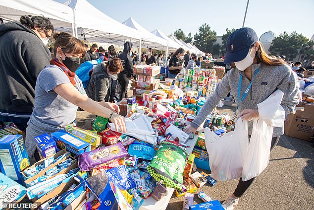 People gather relief supplies at the YMCA distribution center at Pasadena City College after residents fled the Eaton Fire