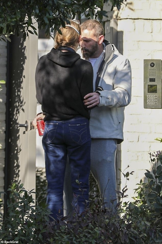 Affleck looked relaxed in a cream jacket over a matching hoodie and gray sweatpants. His dark hair was cut short and he wore a full beard, nicely trimmed