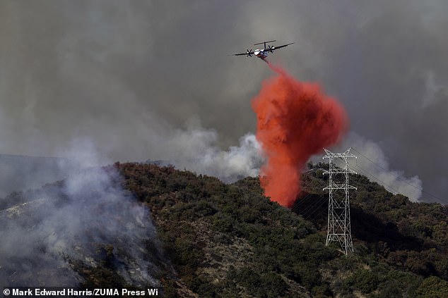 An air tanker drops Phos-Chek flame retardant into Mandeville Canyon during the Palisades Fire