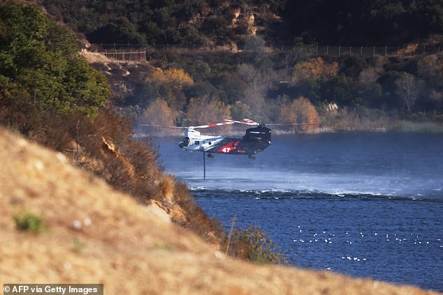 A firefighting helicopter collects water from the Encino Reservoir in Los Angeles - questions have been raised in recent days about the lack of availability of sufficient water