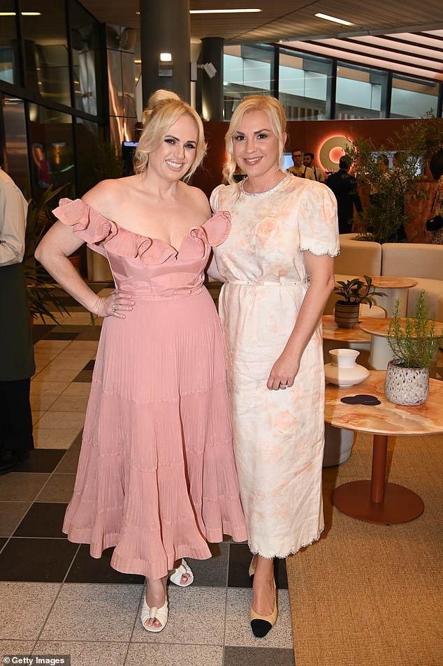 The Pitch Perfect star was hard to miss in an off-the-shoulder ball gown as she attended the Set in Style dinner, wife Ramona Agruma (right)