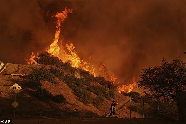 A firefighter is seen battling the Palisades Fire in Mandeville Canyon on January 11