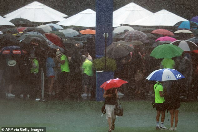 Spectators took cover on the first day of the Australian Open in Melbourne