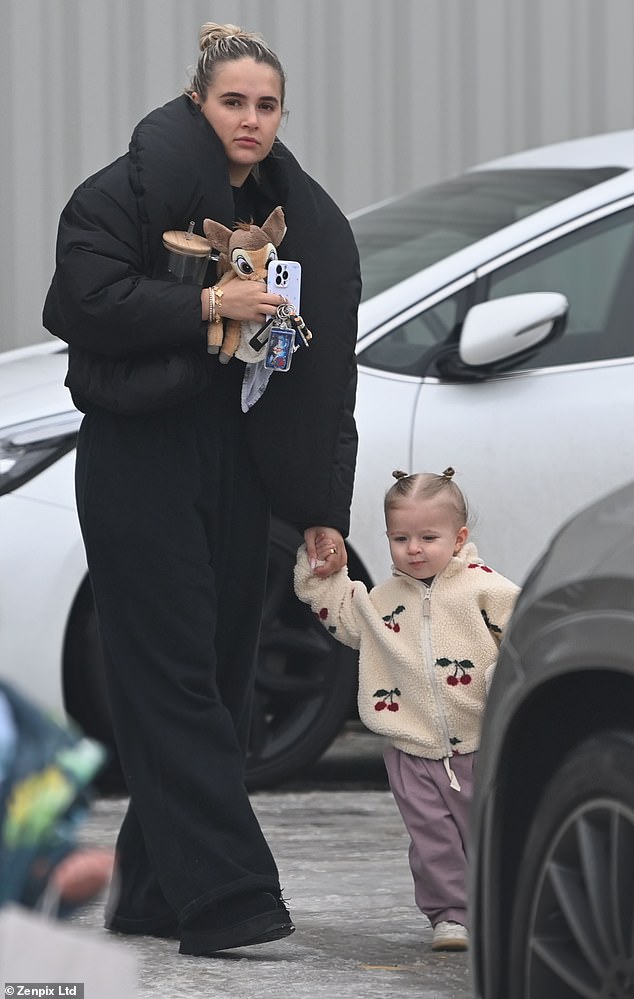 No need for make-up, Molly-Mae opted for an oversized black quilted coat as she and little Bambi headed back to her car.