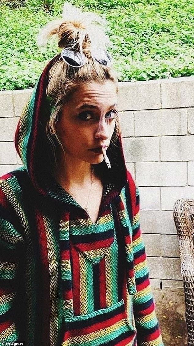 The singer-songwriter poses wearing a 'drug blanket' smock and lights a cigarette in her mouth, the same month she stopped reporting her family was 'terrified' about her alleged drug use