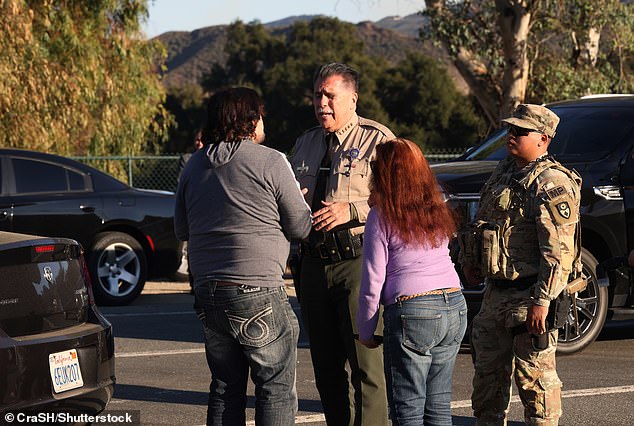 ) LA County Sheriff Robert Luna talks to Malibu residents evacuated due to fires