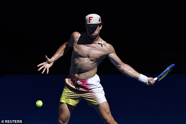 Shelton (pictured on the practice court at Melbourne Park) has the biggest serve in tennis - and his shirtless performances have won him plenty of fans too