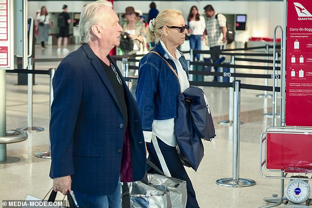 Carrying their luggage through the terminal, the pair went incognito as the 60 Minutes star hid her eyes behind a pair of dark sunglasses