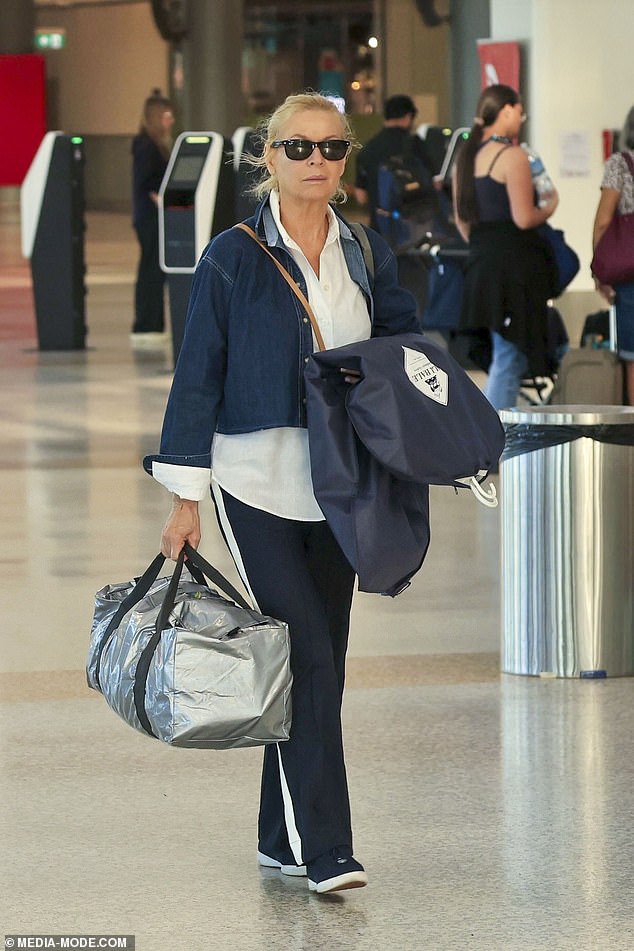 Liz looked very chic in a casual, layered ensemble with a cropped blue denim jacket thrown on over a white button-down.