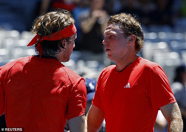 The Greek fan favorite dropped the first two sets to unseeded American Alex Michelsen (pictured with Tstitpas after match point), who recorded the biggest win of his career