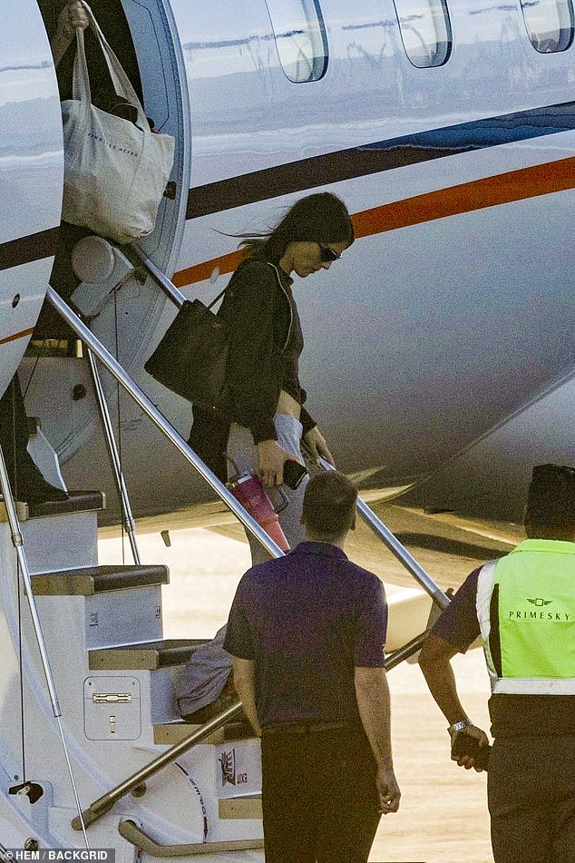 Dressed in a casual hoodie and baseball cap, Leo seemed unfazed as he stepped off the plane next to 26-year-old Ceretti, who wore an all-black ensemble.