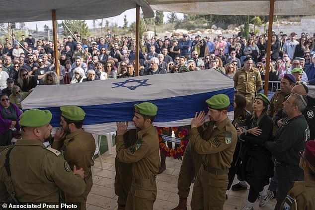 Israeli soldiers and relatives carry the flag-draped coffin of Sergeant Yahav Maayan, who died in combat in the Gaza Strip, during his burial at a military cemetery in Modiin, Israel on Sunday