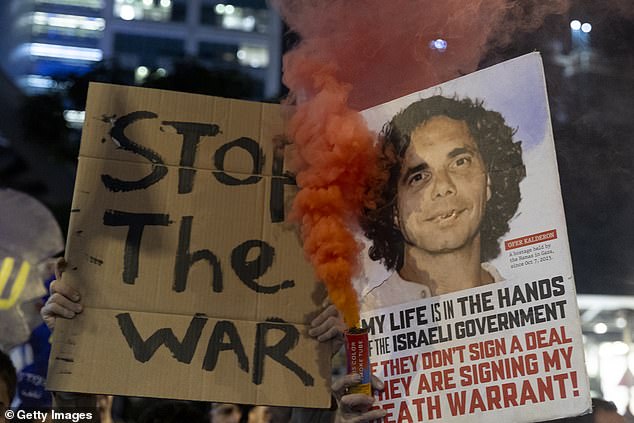 Protesters hold photos of hostages during a demonstration calling for a hostage deal for the release of hostages held in the Gaza Strip by Hamas in Tel Aviv, Israel