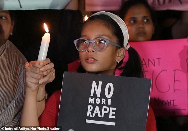 A child pictured at a vigil to condemn the rape and murder of a trainee doctor at a government-run hospital in Calcutta, on a street in Mumbai, India, on August 14