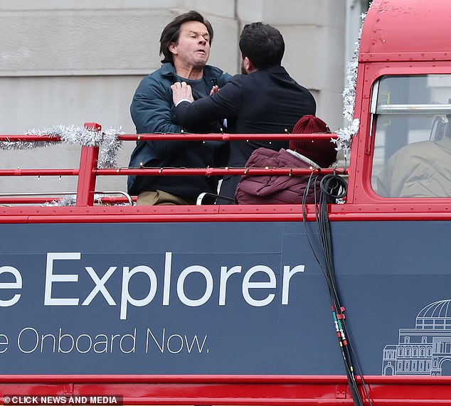 Mark struggled with Kit as the London bus passed through Whitehall on Monday morning