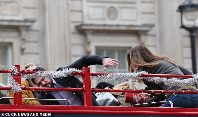 Kit appeared to lose his balance as the bus sped through the busy tourist district