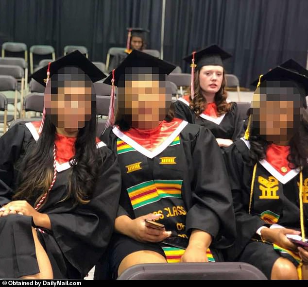 Strotman, pictured in the back row at her graduation ceremony, has so far only been accused of abusing one baby