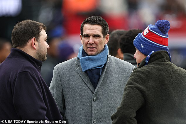 New York Giants general manager Joe Schoen, center, on the field before a recent game