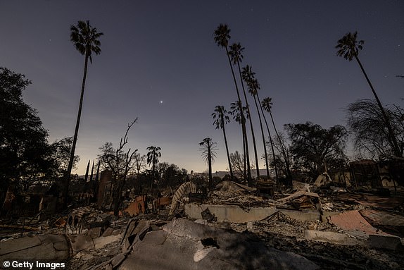 ALTADENA CALIFORNIA - JANUARY 12: Homes destroyed in the Eaton Fire are left in the dark of night on January 12, 2025 in Altadena, California. The death toll from the Eaton fire rose to 16 today as search and rescue teams sift through the ruins of thousands of homes. More than 7,000 buildings, mostly homes, were damaged or destroyed when strong winds in Santa Ana pushed the flames further into the city than even many fire experts expected. (Photo by David McNew/Getty Images)