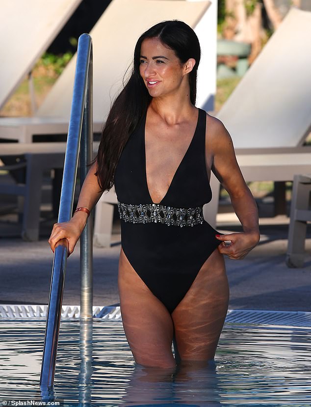 The reality star showed off her beautiful smile as she climbed into the pool