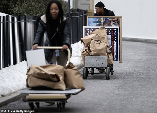 People move bags saying "Unclassified only" and paintings from the White House as the Bidens prepare to leave and the Trumps prepare to move in