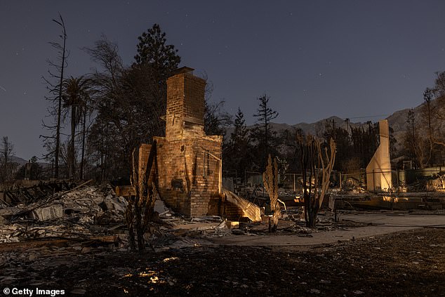 Homes destroyed by the Eaton Fire are left in the dark of night in Altadena, California on January 12, 2025