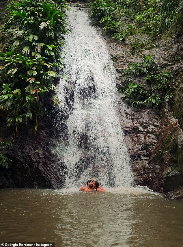 Keeping her followers updated on her travels, another photo saw the pair lock lips under an incredible waterfall