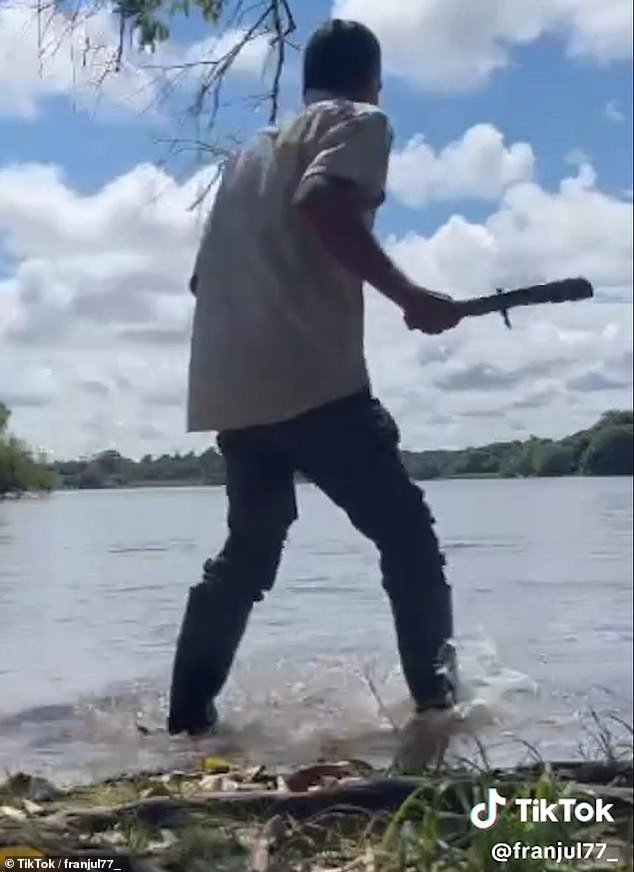 A man armed with a stick arrives on the scene to help