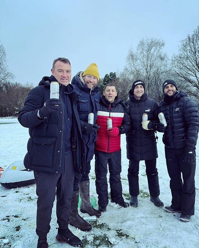 Walker (right) was photographed drinking beer in the snow with his friends – including City Kit assistant Adam Smith (second from right) – earlier this week