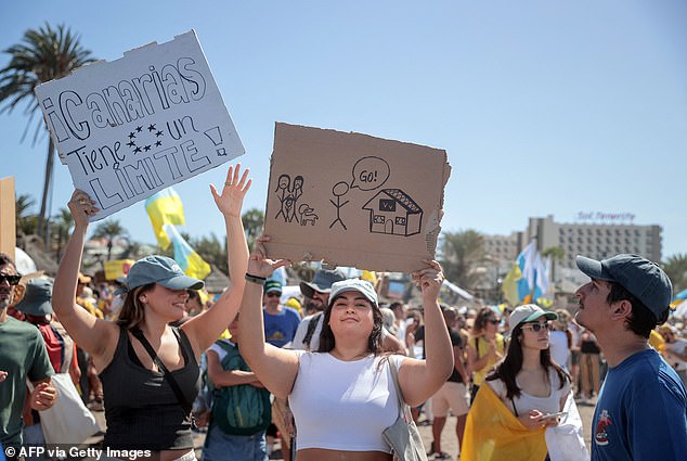 A protester holds a sign 