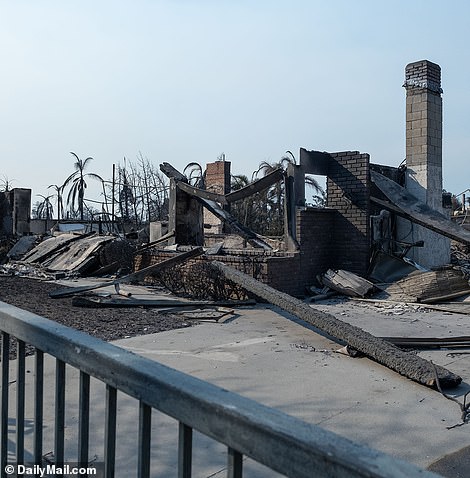 Now the walls and foundation beams are charred and only some bricks from the old chimneys remain