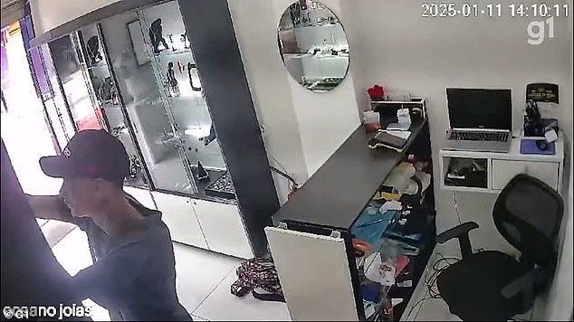 A robbery suspect ransacks a counter while stealing jewelry from a store in Brazil, moments before residents intercepted him on the street and held him until police arrived