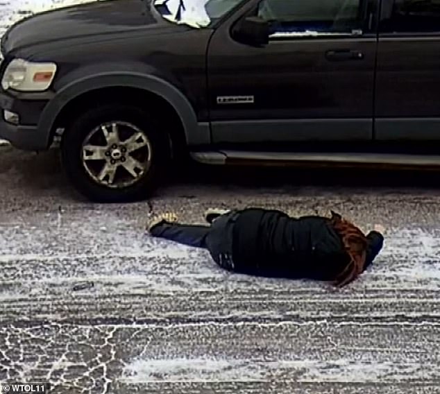 The woman moved slightly after being thrown to the ground. Then she lifted her head and placed it in her hands