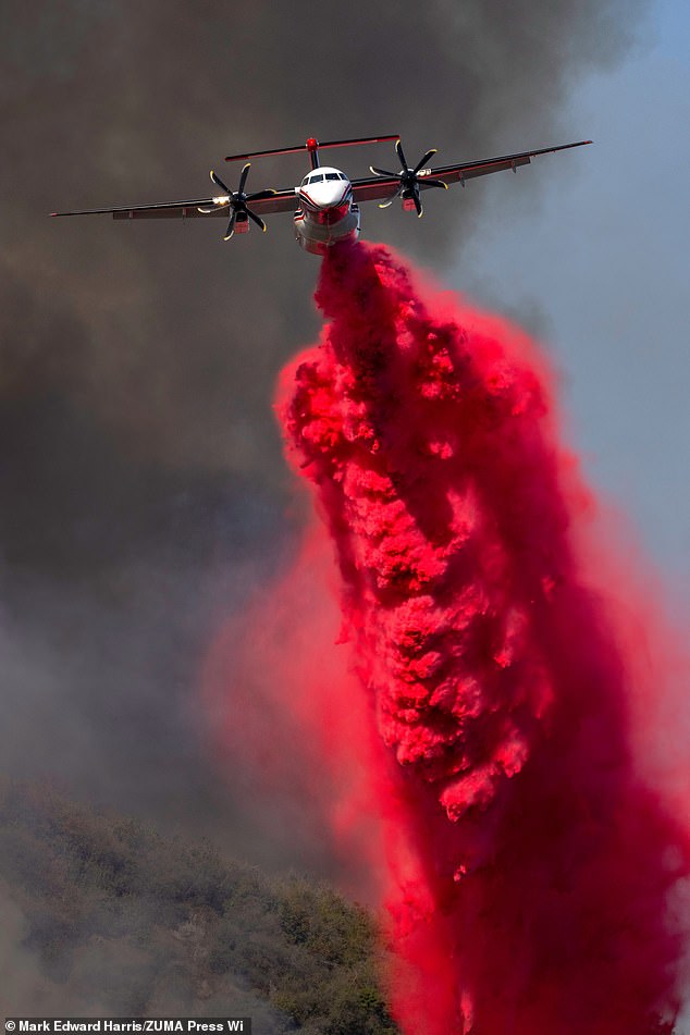 An air tanker drops Phos-Chek flame retardant into Mandeville Canyon during the Palisades Fire