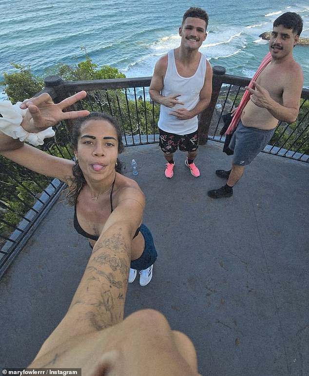 A third shot showed Fowler (left) posing for a selfie at a lookout while hiking with Cleary and a friend (pictured right)