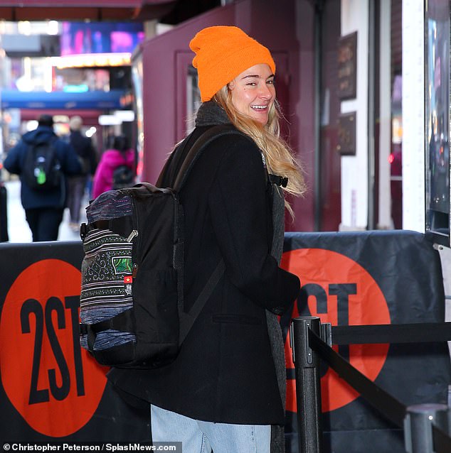 Her long blonde hair fell from a bright orange cap as it hung close to Roberta's side