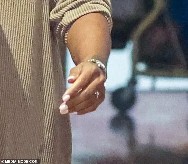 The singer showed off a huge diamond on her engagement finger as she attended a movie premiere with her friend Heath Keating in Sydney