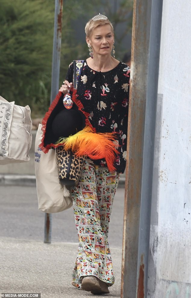 The former TV star looked sharp in a quirky black and white top decorated with cartoon characters and Mickey Mouse printed trousers as she left the cruise ship.