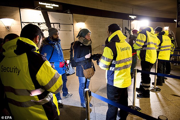 Security personnel check IDs of travelers from Denmark to Sweden as part of measures to reduce the flow of migrants into the country in 2015