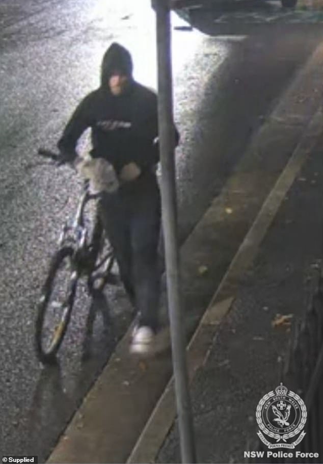 A man was seen pushing a mountain bike down the street (pictured)