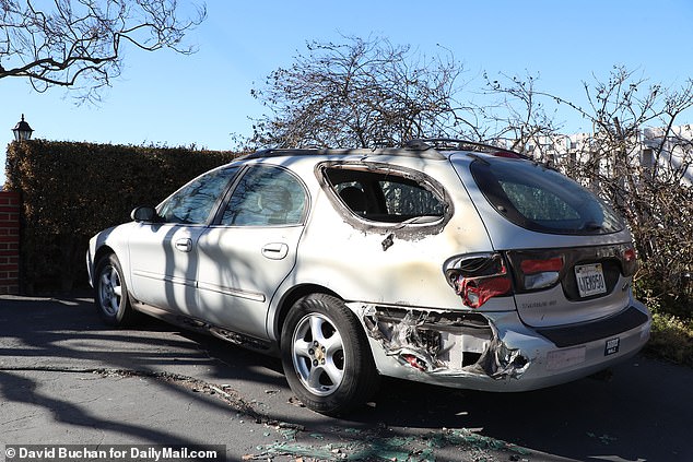 The remains of a Ford Taurus can be seen outside the property belonging to the Kerrs