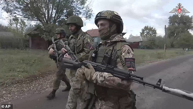 DFAT officials are investigating reports that Mr Jenkins was executed by Russian soldiers. The photo shows Russian soldiers patrolling a village on the Ukrainian border