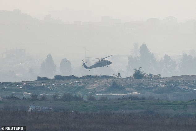 An Israeli Black Hawk military helicopter lands in northern Gaza on January 14, amid the ongoing conflict between Israel and Hamas