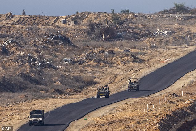 Israeli military vehicles enter the Gaza Strip on January 7, as seen from southern Israel