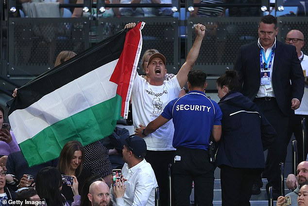 The rules state that anyone waving a banned flag during the Grand Slam will be removed from the venue and subject to arrest (2024 Open demonstrator pictured)