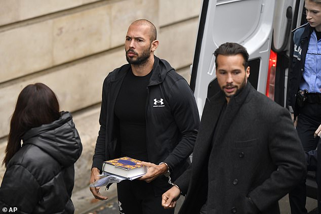 Andrew Tate, center, and his brother Tristan, right, are brought before the Court of Appeal in Bucharest, Romania by police officers